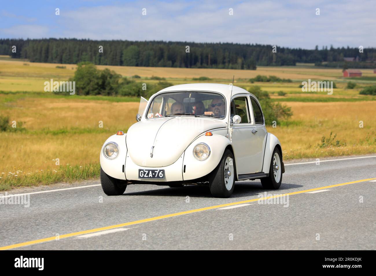 Biancastro Volkswagen Beetle, ufficialmente Volkswagen tipo 1, guidando lungo la strada di campagna sulla crociera in auto Maisemaruise 2019. Vaulammi, Finlandia. Agosto 3, 20 Foto Stock
