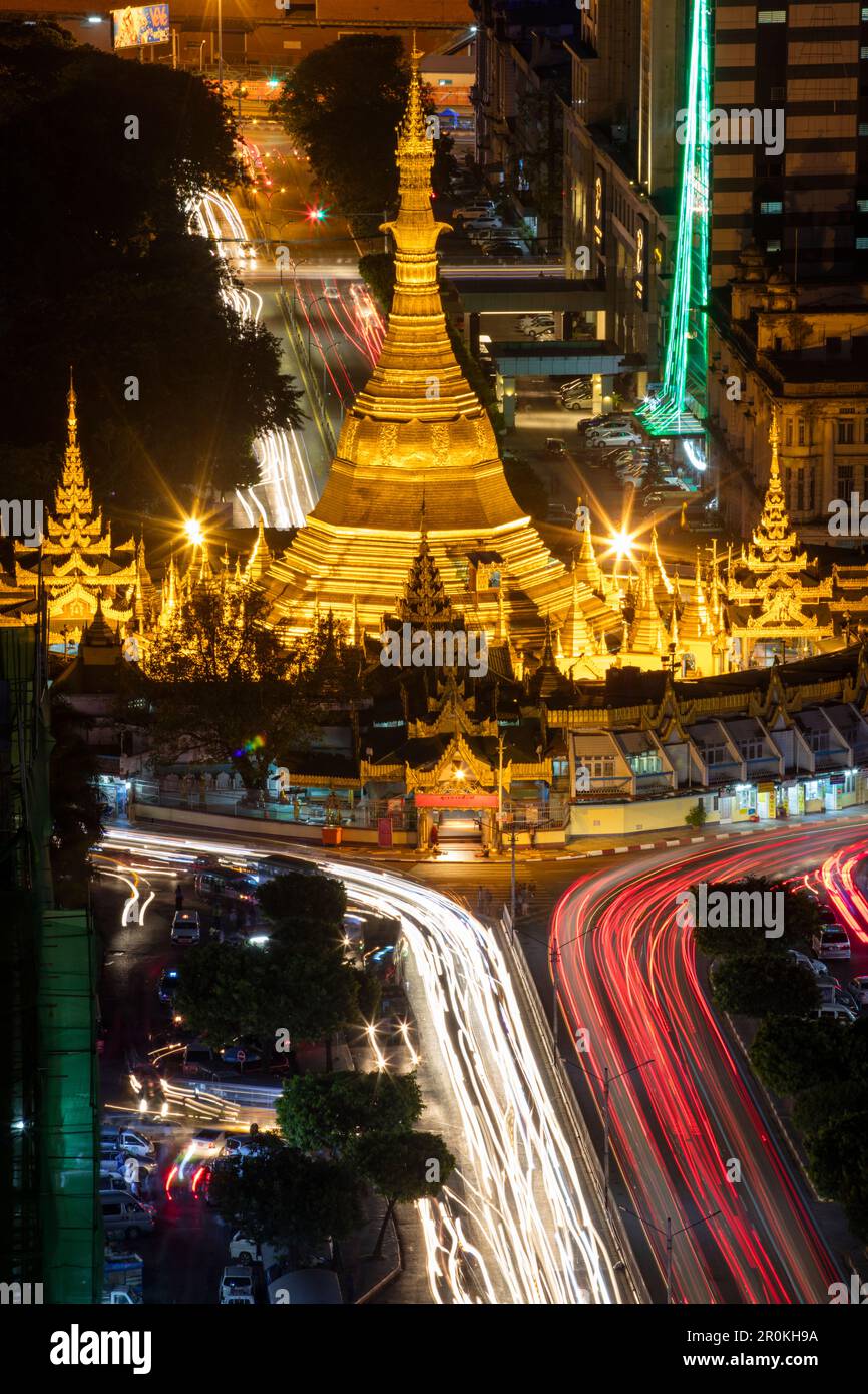La testa della Pagoda di Sule illuminata e le strisce di luci dell'automobile sulla strada della Pagoda di Sule viste dalla Torre di Sakura durante la notte, Yangon, Yangon, Myanmar Foto Stock