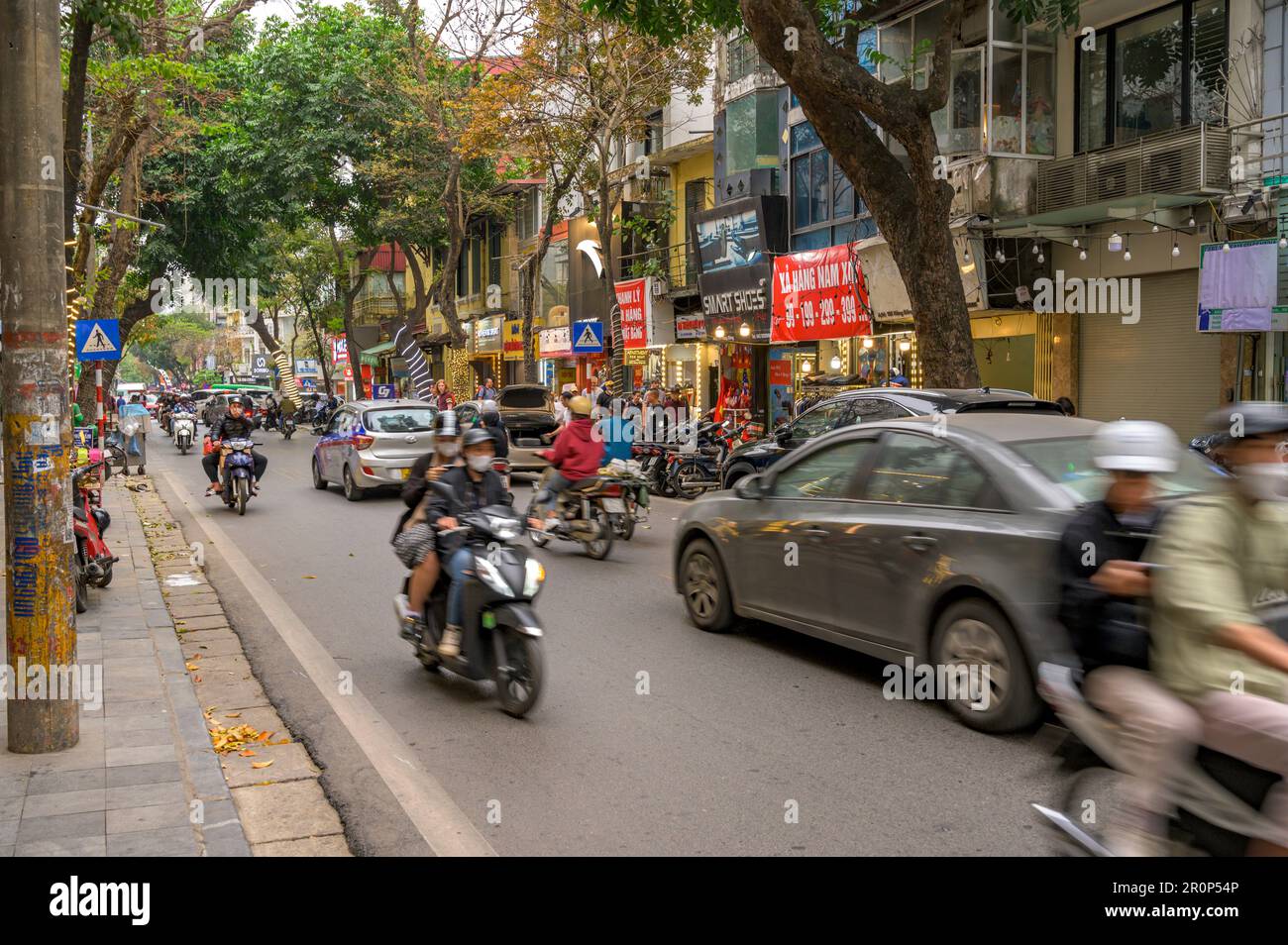 Strada trafficata scena con diversi modi di trasporto nel centro storico di Hanoi, Vietnam. Foto Stock