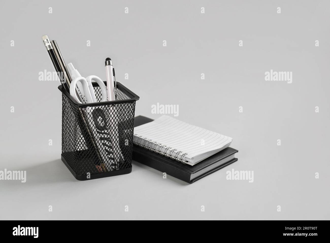 Porta cancelleria e quaderni su sfondo grigio Foto stock - Alamy