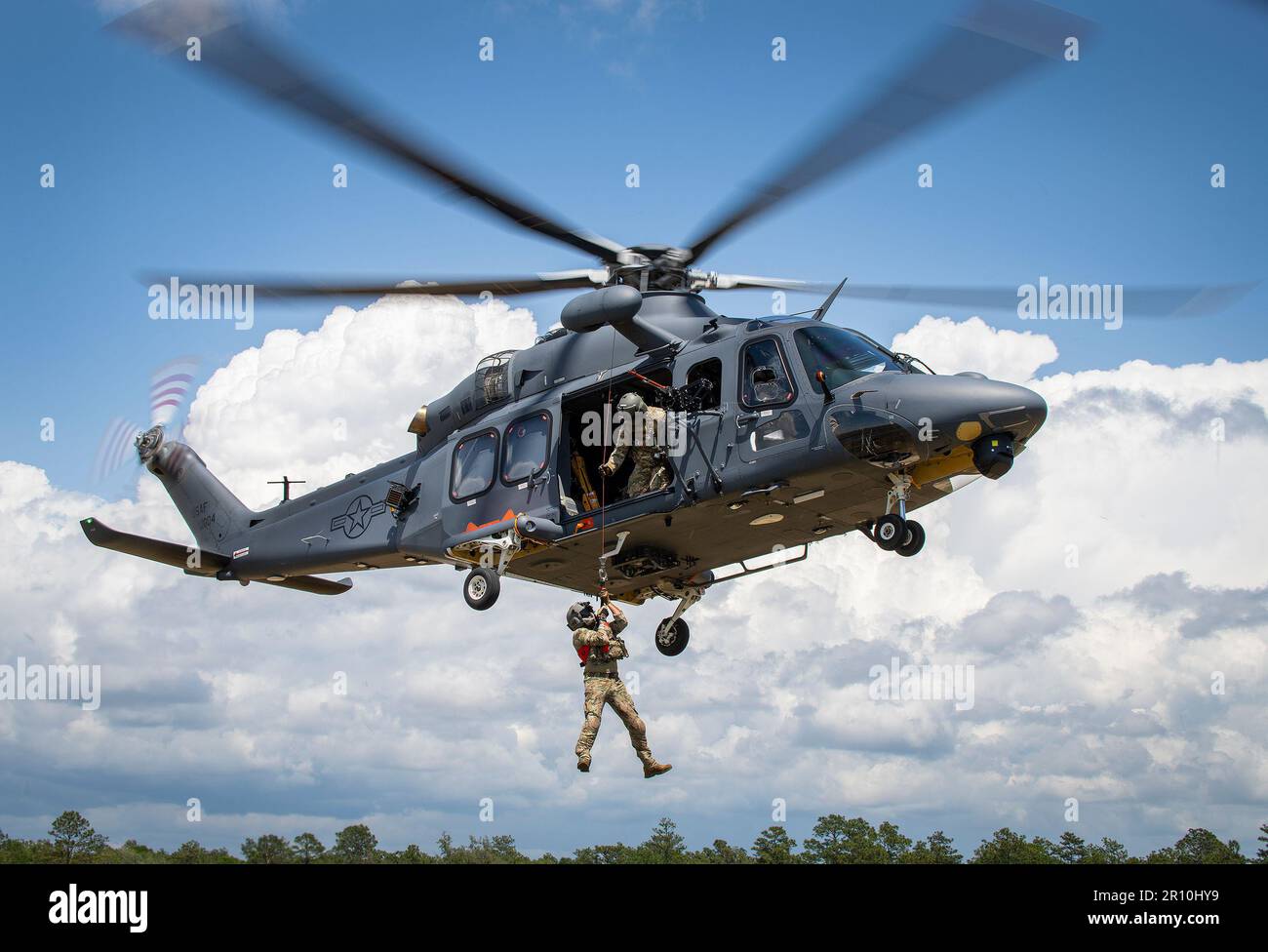 Un lupo grigio MH-139A solleva Master Sgt. Michael Wright, un aviatore di missione speciale del comando globale di attacco dell'aeronautica militare distaccato 7, in aria il 26 aprile alla base dell'aeronautica militare di Eglin, la L’aeromobile ha completato con successo il primo test di sollevamento in tensione che ha portato a termine gli SMA attraverso l’enorme penetratore della foresta e il soccorso. Il 413th Flight Test Squadron e Det. 7 ha lavorato insieme per raggiungere un altro traguardo per il nuovo elicottero dell'aeronautica militare. (STATI UNITI Foto dell'aeronautica/Samuel King Jr.) Foto Stock