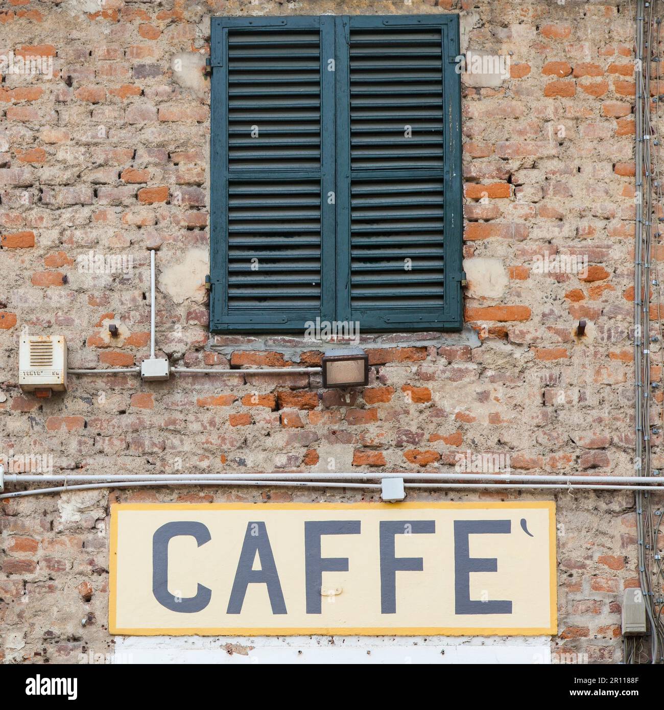 Toscana, Italia. Cartello Old caffe sotto una tradizionale finestra italiana Foto Stock