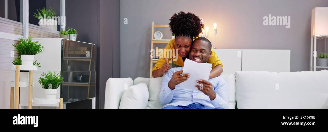 Lettera giovane Famiglia Coppia lettura Good News Paper Foto Stock