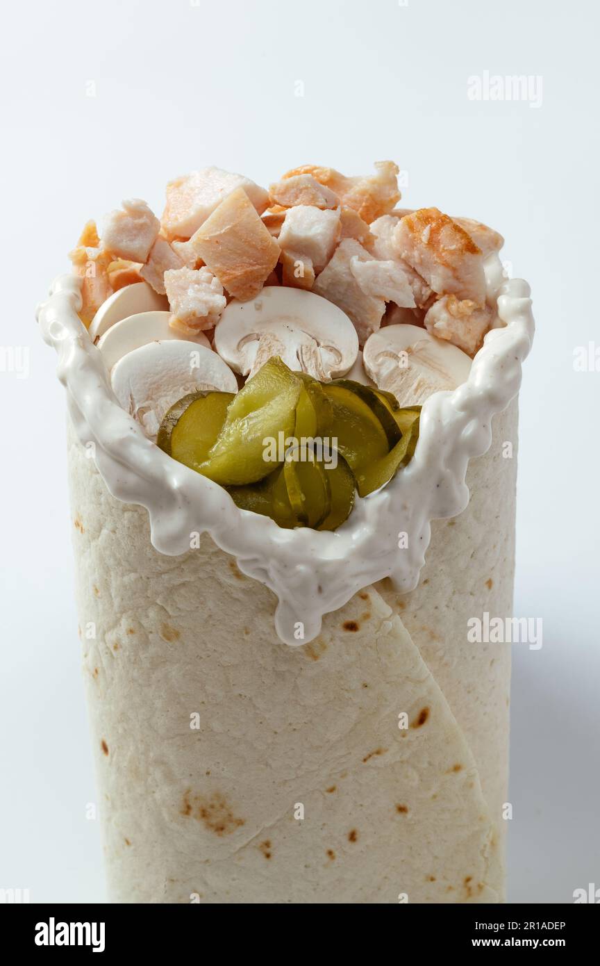 Shawarma di pollo in pita Brot e insalata fresca e salsa succosa su sfondo di legno Foto Stock