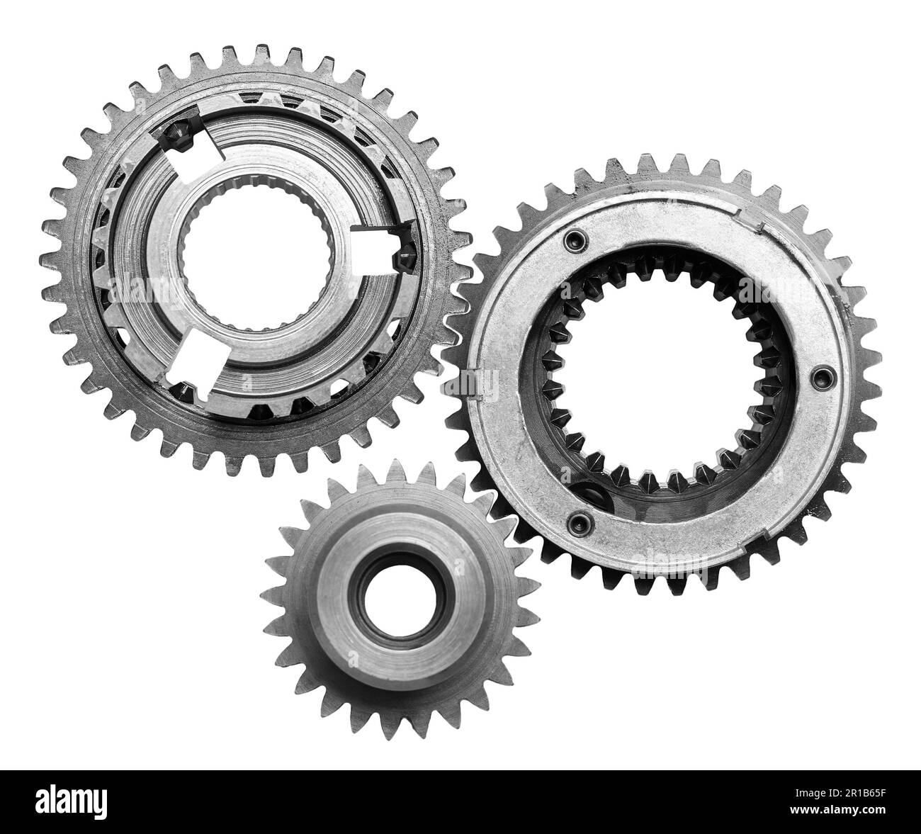 Set con diversi ingranaggi in acciaio inox su sfondo bianco, vista dall'alto Foto Stock