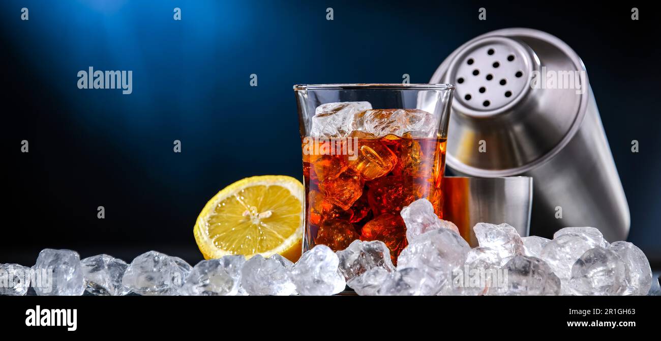 Composizione con una bevanda alcolica e un cocktail shaker Foto Stock