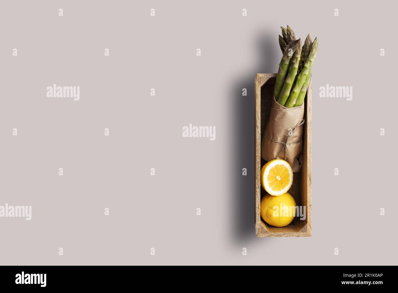 Vista su limoni e asparagi isolati su sfondo di legno. adatto per il progetto. Foto Stock