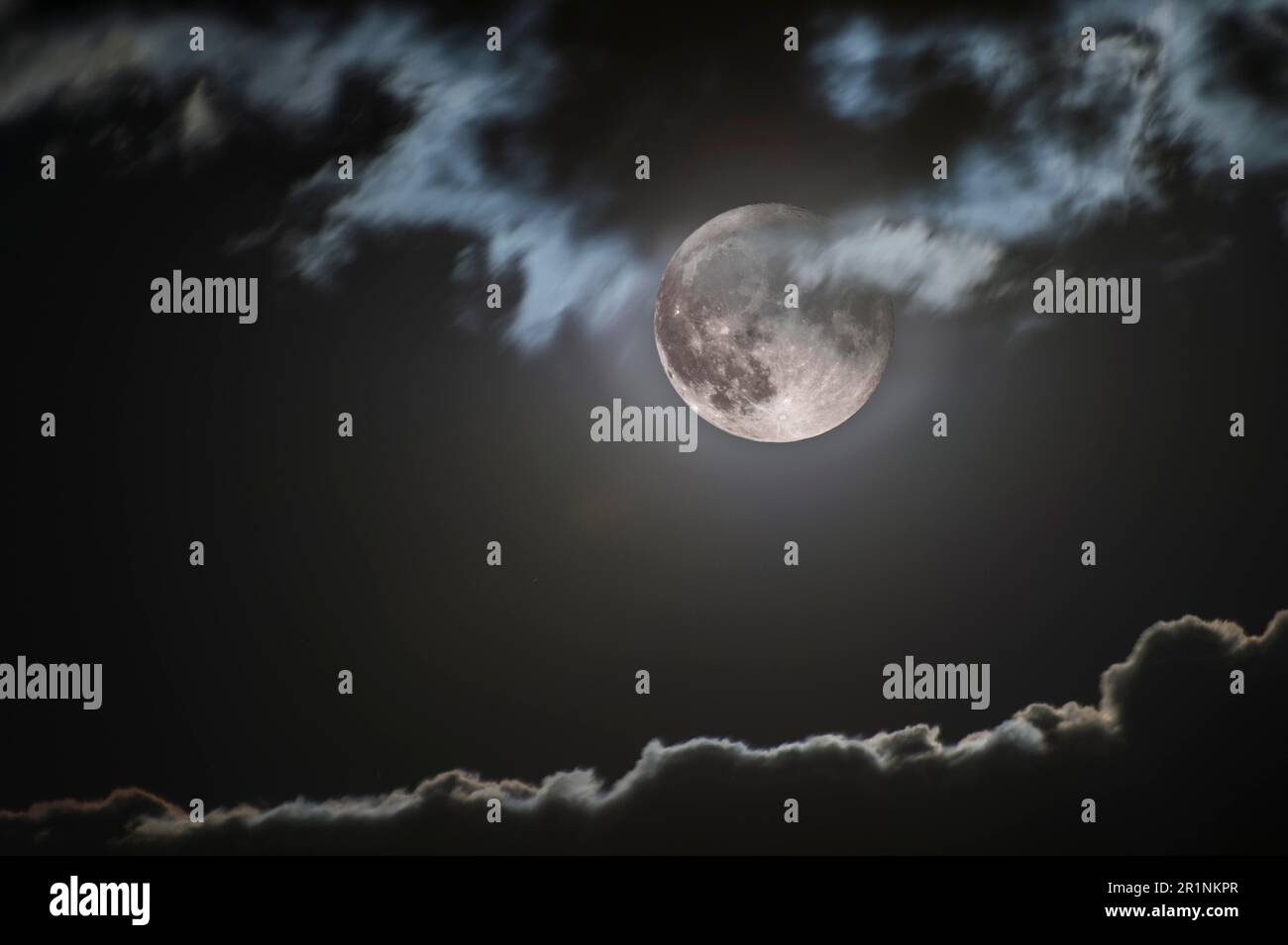 La luna piena che sale illumina il bordo frastagliato della nuvola, Vallese, Svizzera Foto Stock