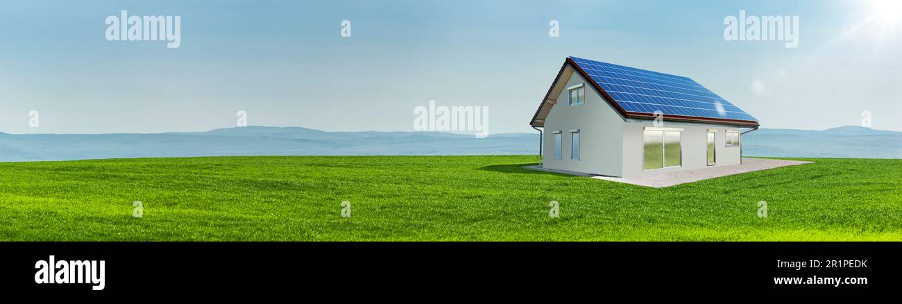 Turbine eoliche e celle solari sul tetto di una casa in un prato verde Foto Stock