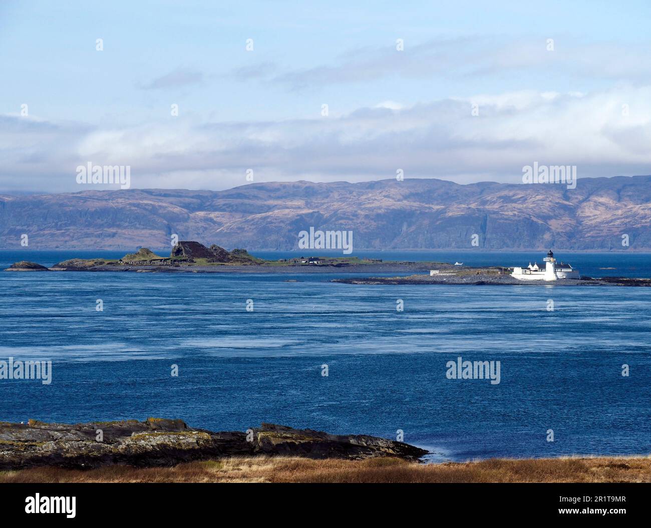 Faro, Fladda, con Belnahua dietro, Slate isole, Scozia Foto Stock