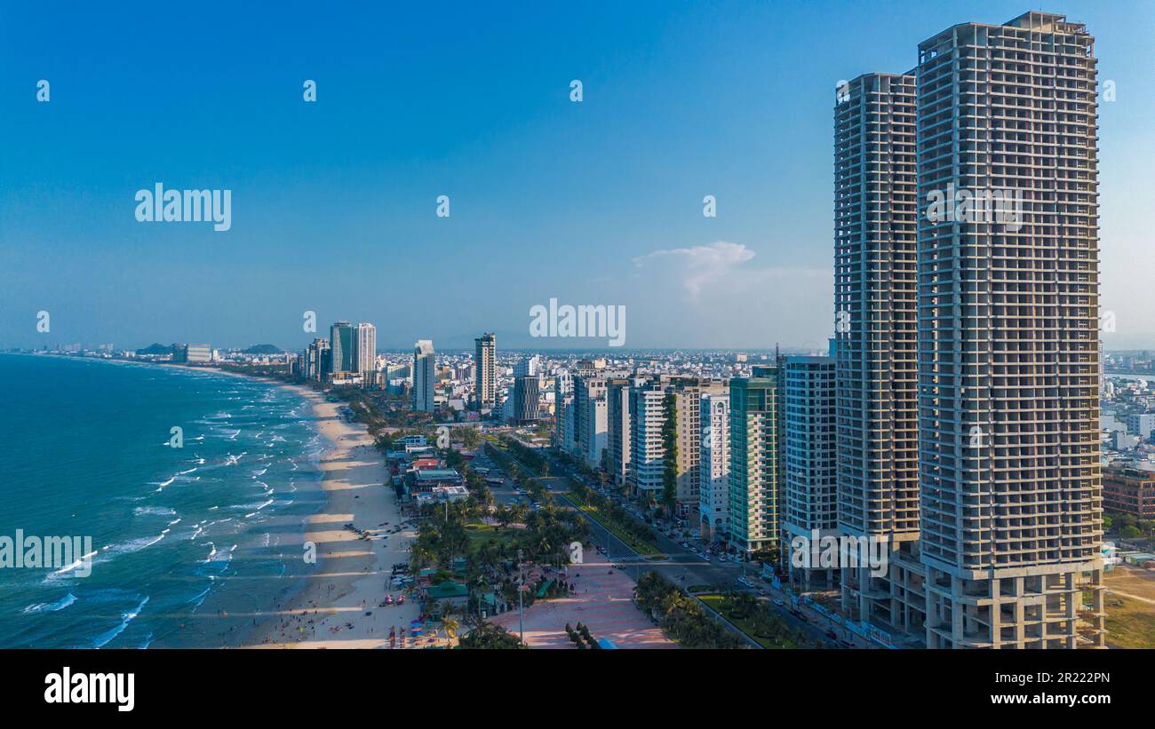 Vista aerea del tramonto sulla costa di da Nang. Spiaggia di My Khe con alti hotel e grattacieli sulla spiaggia di sabbia dorata Foto Stock