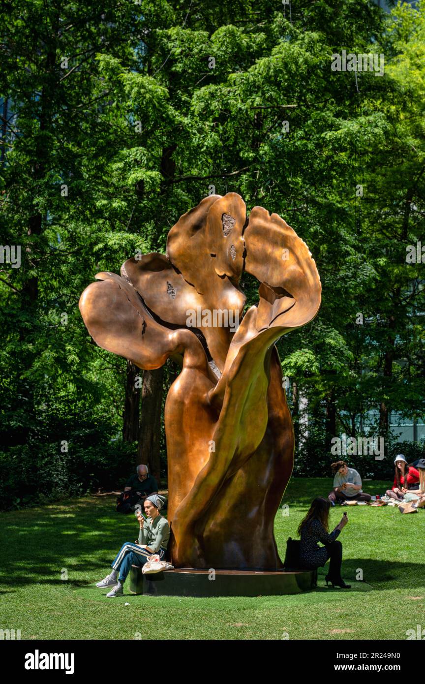 Londra, Inghilterra - 20 giugno 2022: Un gruppo di persone seduto vicino alla scultura Fortuna di bronzo di Helaine Blumenfeld Foto Stock