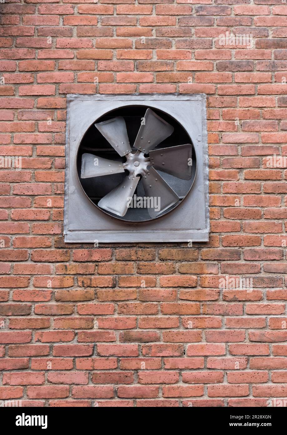 Ventilatore sullo sfondo della parete di mattoni Foto Stock