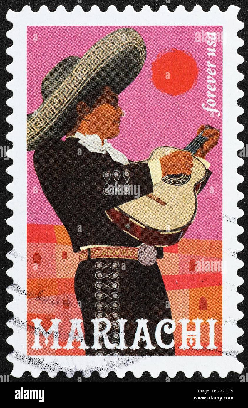 Giovane mariachi con la sua chitarra su francobollo americano Foto Stock