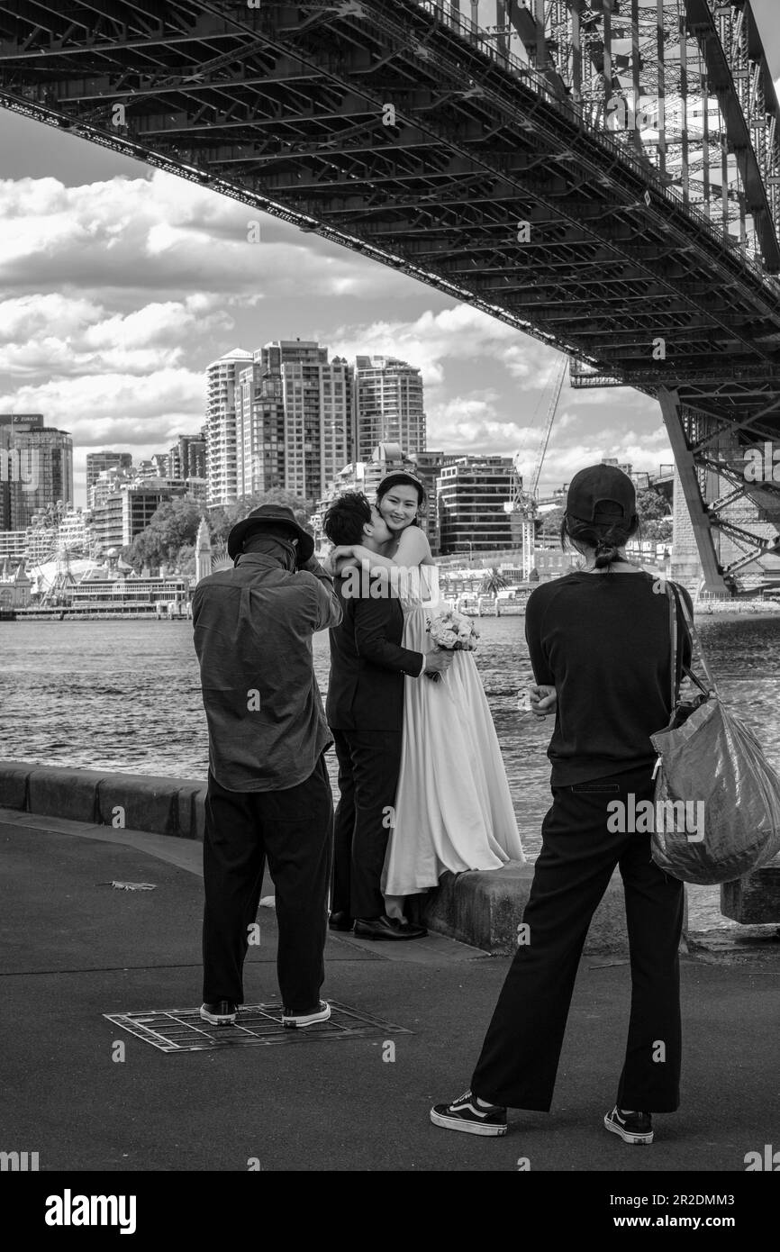 Una coppia asiatica che ha foto di matrimonio scattate sotto Sydney Harbour Bridge, Australia Foto Stock
