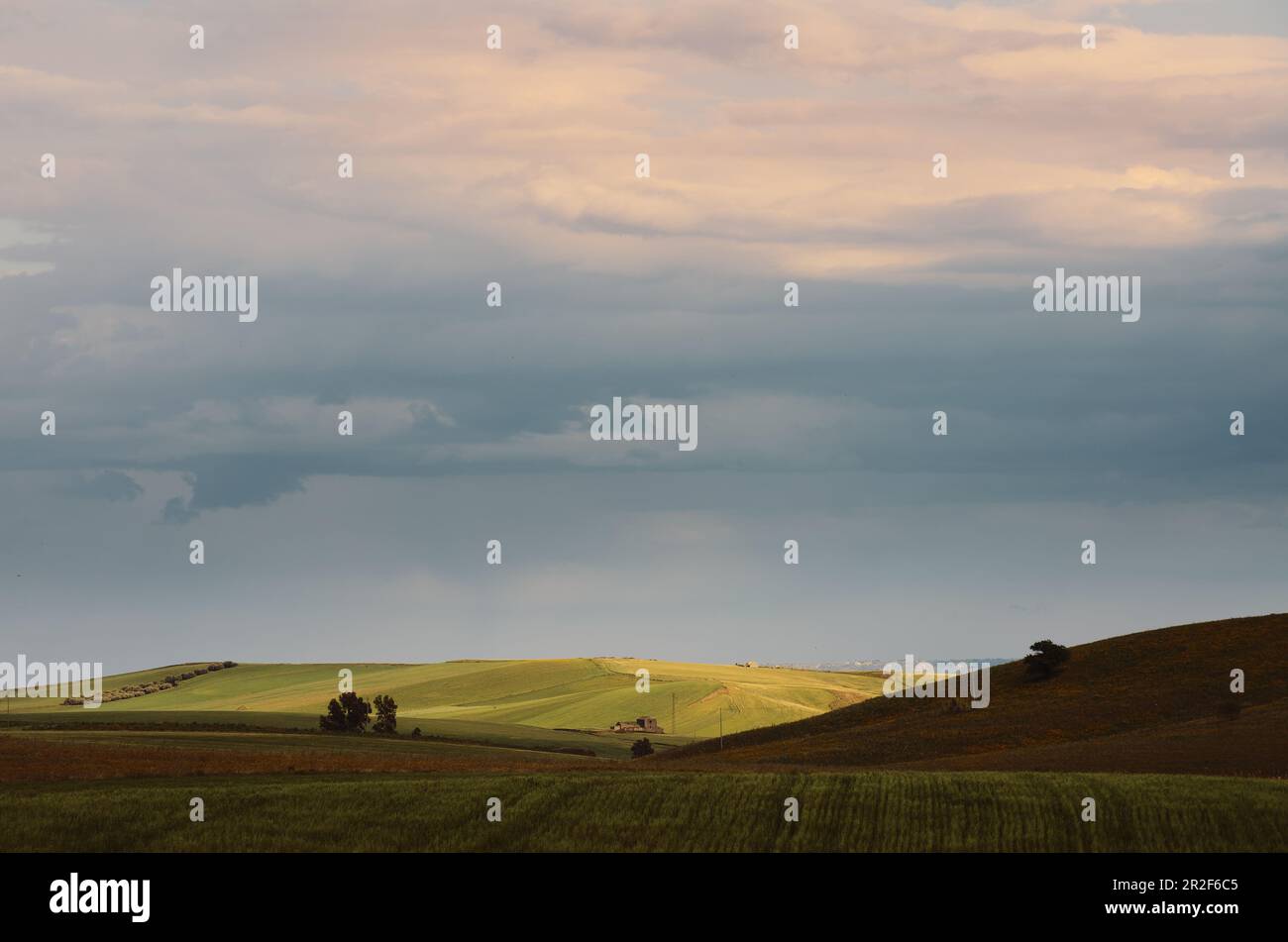 Acquerello colori del cielo sovrastato sui campi al tramonto nella Sicilia rurale, Italia Foto Stock
