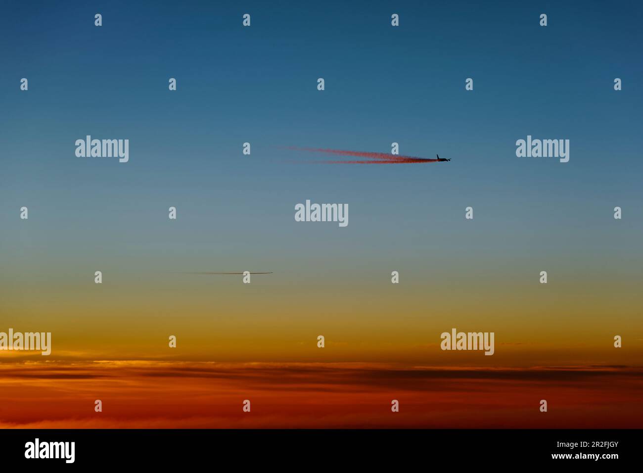Aeroplano con contraddii appena prima dell'alba Foto Stock