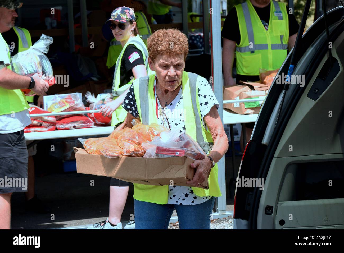 Orlando, Stati Uniti. 19th maggio, 2023. I volontari collocano gli articoli alimentari in veicoli in occasione di un evento di distribuzione alimentare militare e veterano per coloro che ne hanno bisogno, sponsorizzato da Lockheed Martin e dagli angeli nazionali no profit Soldiersí presso la clinica del Lago Baldwin VA di Orlando. In riconoscimento del mese dell'apprezzamento militare, 200 veterani preregistrati dell'area di Orlando, militari attivi, guardiani e riservisti hanno ricevuto in media 75 libbre di frutta e verdura fresca, carni e non-deperibili all'evento. Credit: SOPA Images Limited/Alamy Live News Foto Stock