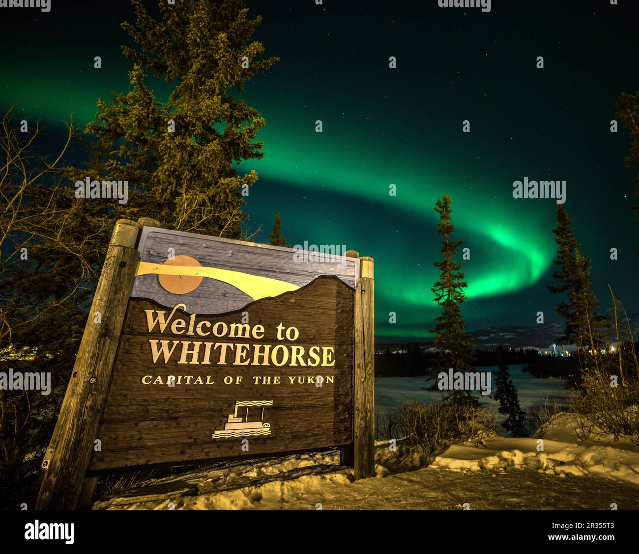 Visualizzazione dell'aurora boreale nel Canada settentrionale, territorio dello Yukon. Benvenuti al cartello Whitehorse con la band aurora borealis sopra la città selvaggia. Foto Stock