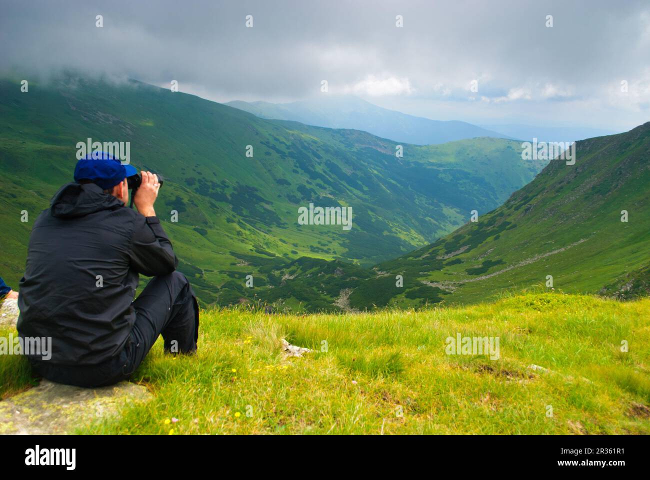 L'uomo guarda sulle montagne Foto Stock