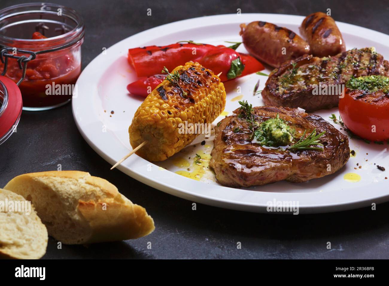 Un piatto di carne alla griglia, salsicce e verdure Foto Stock