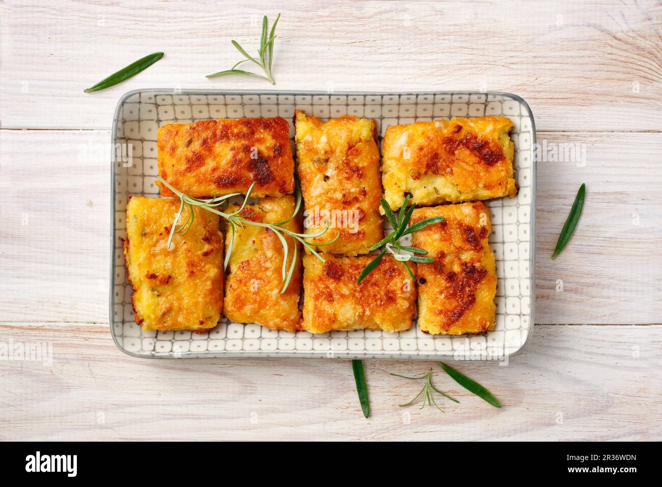 Fette di polenta con parmigiano e rosmarino Foto Stock