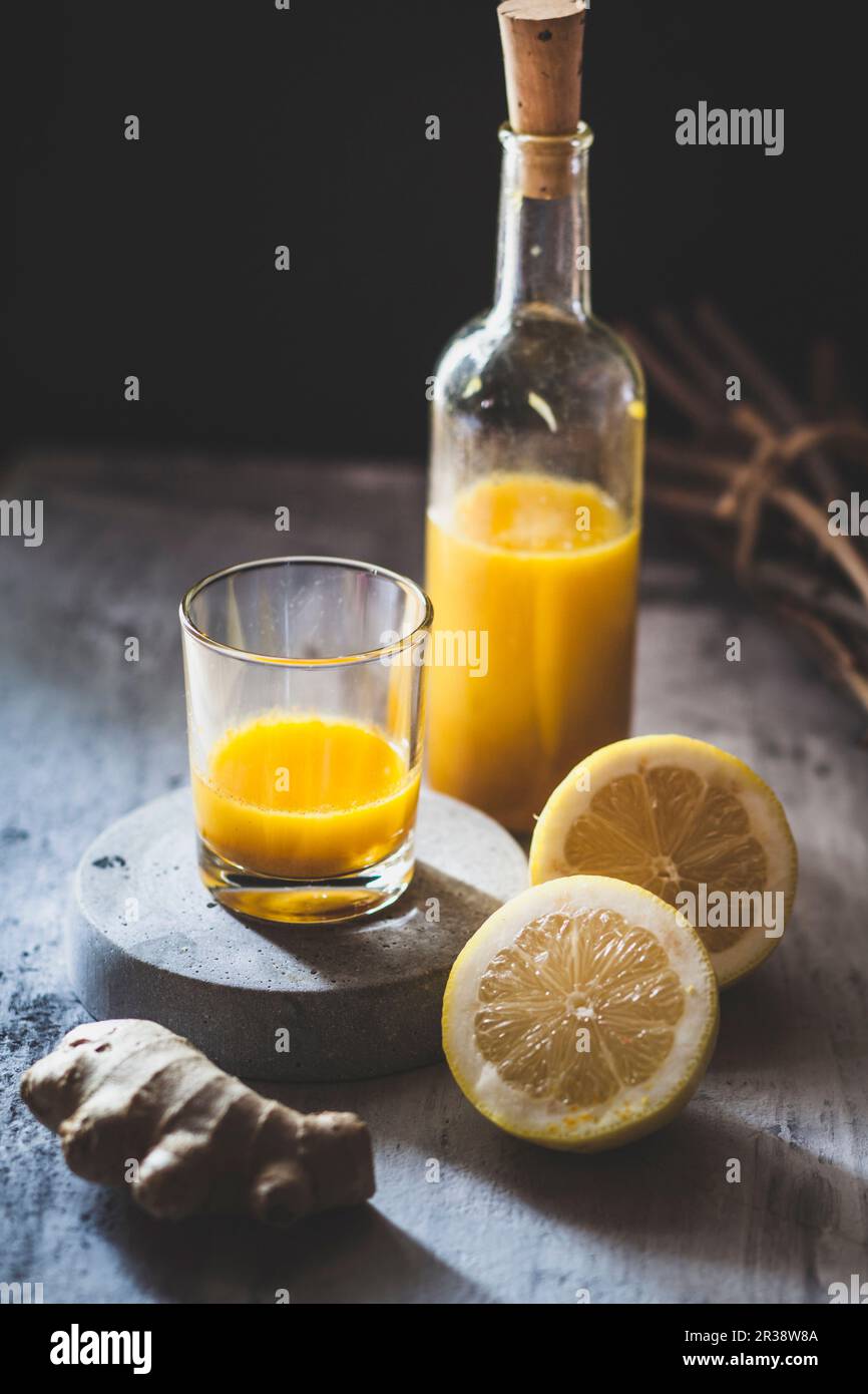 Detox e zenzero con succo di zenzero, succo d'arancia, succo di limone, curcuma e peperoncino Foto Stock