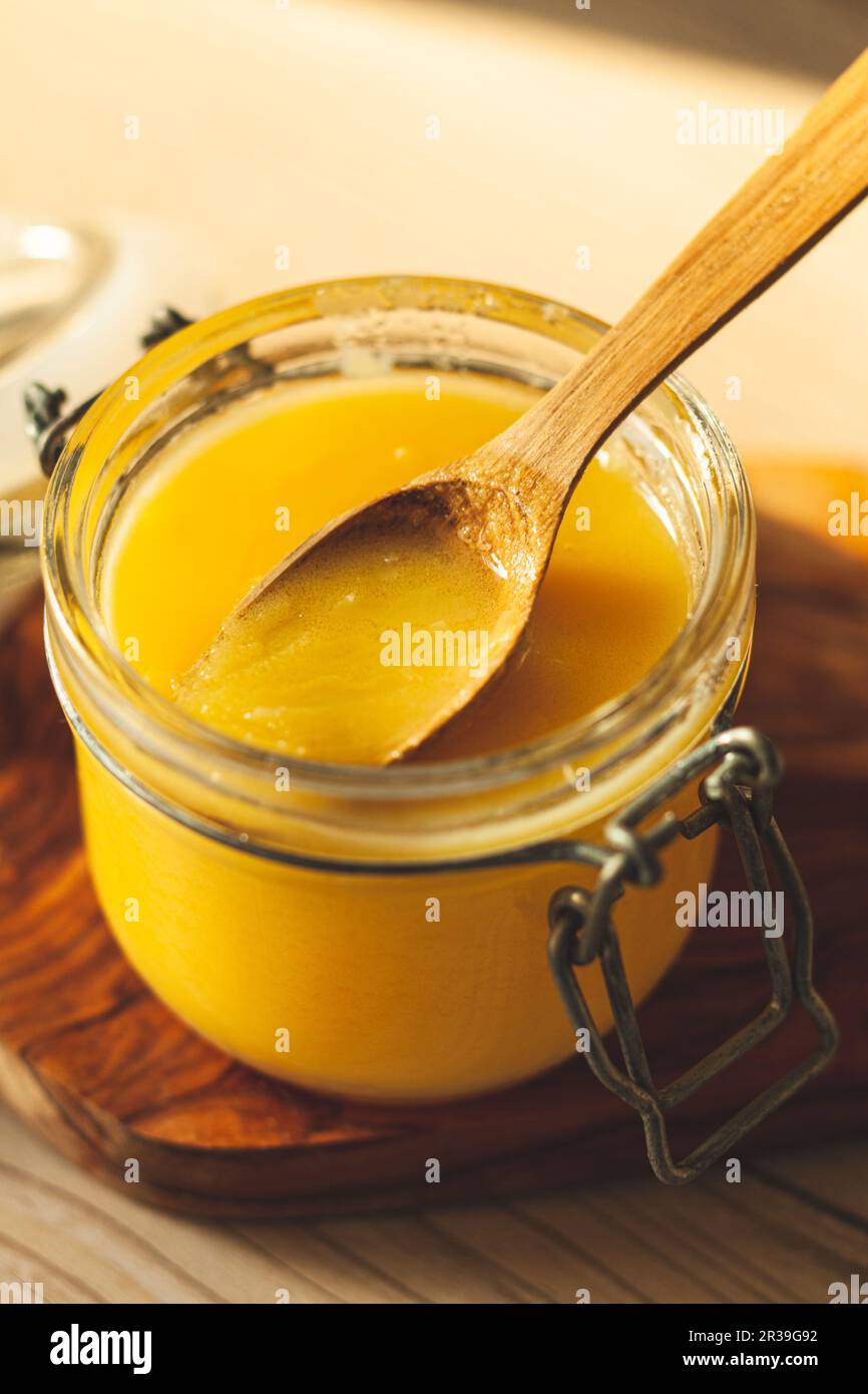 Primo piano di cucchiaio di legno con burro chiarificato Foto Stock