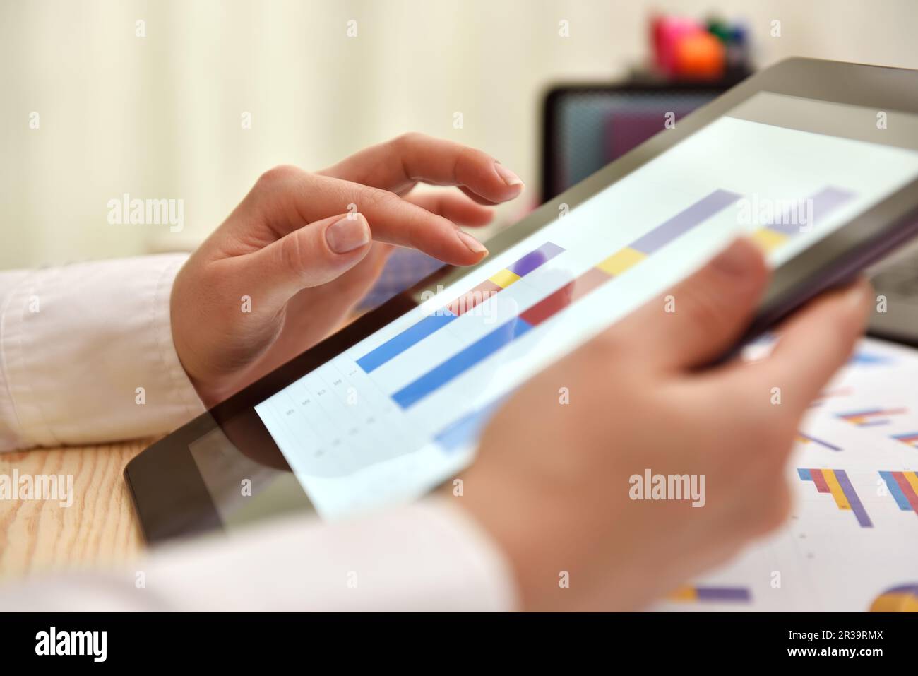 Tablet digitale con dati finanziari sotto forma di grafici e diagrammi sullo schermo. Primo piano Foto Stock