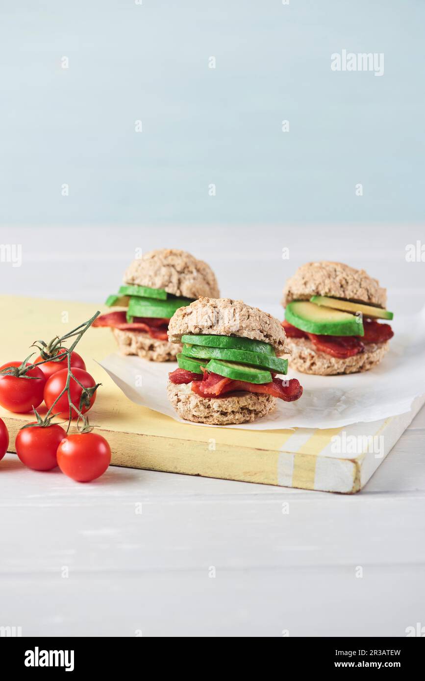 Panini per la colazione con pancetta, avocado e tomatos Foto Stock