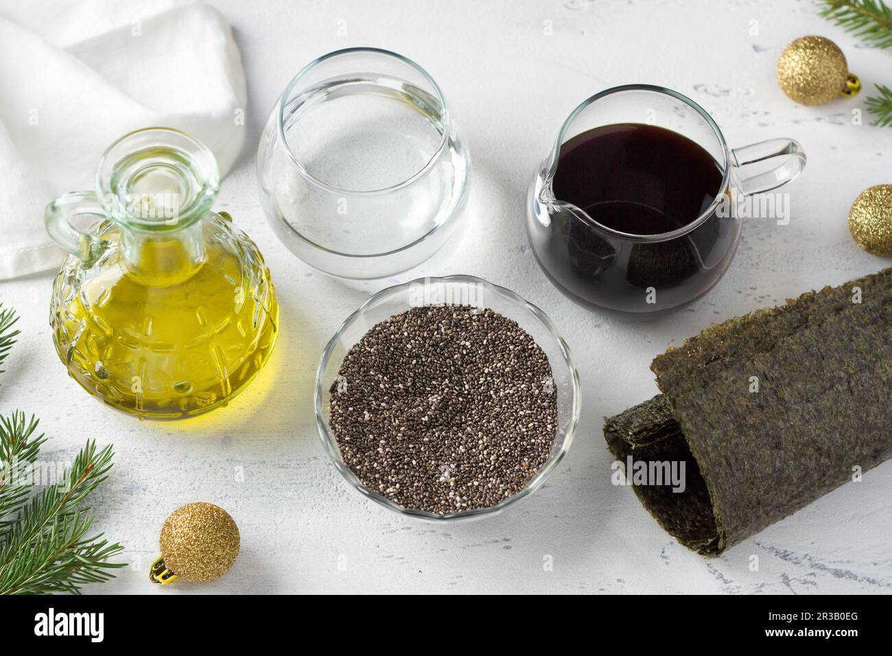 Ingredienti per il caviale nero vegano: Semi di chia, salsa di soia, olio di lino, acqua e nori su sfondo azzurro, vista dall'alto Foto Stock