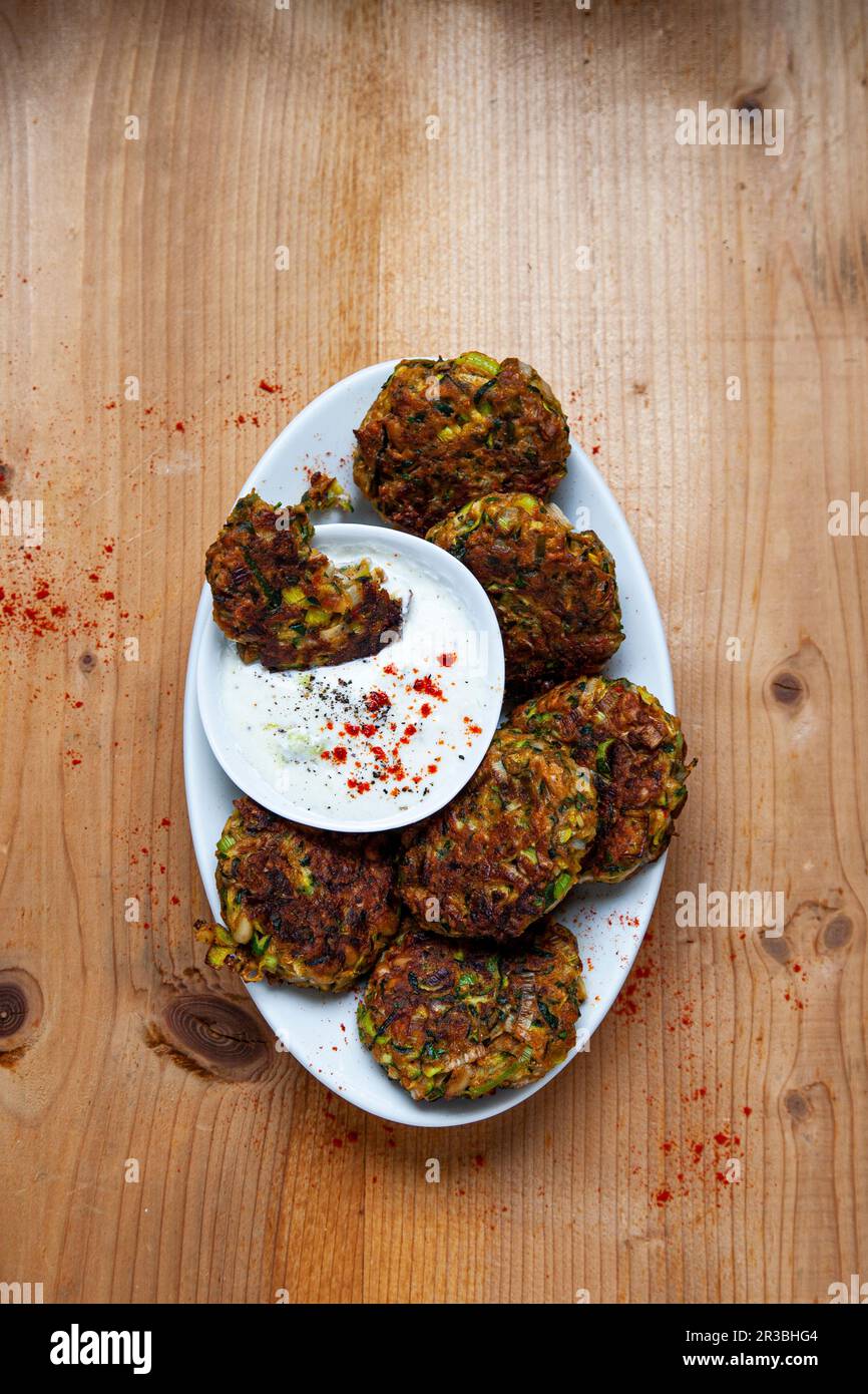 Polpettine di zucchine e porri con salsa al cetriolo e yogurt Foto Stock