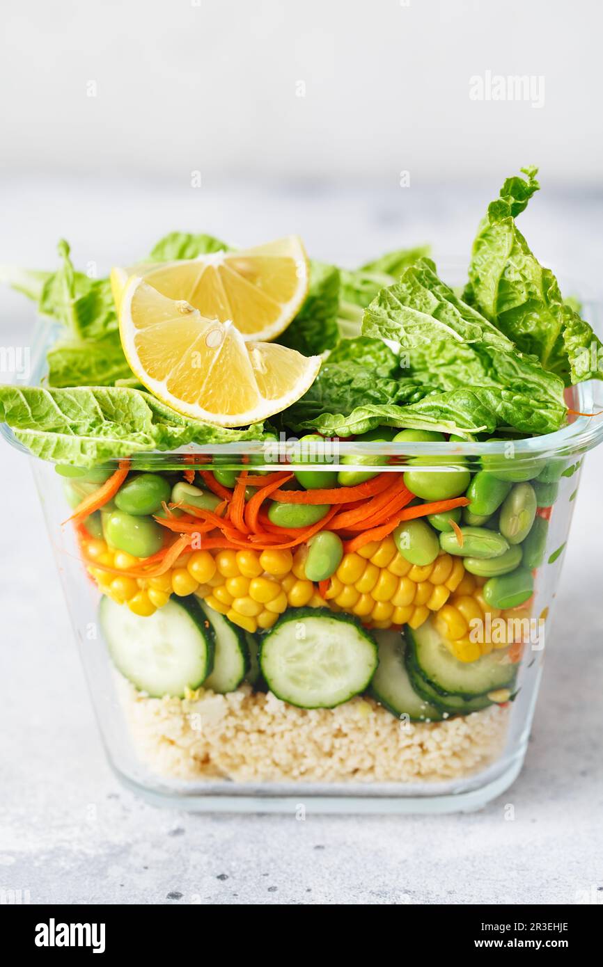Scatola di vetro con insalata di verdure crude fresche. Preparazione di ricette salutari. Piatti vegani sani in contenitore di vetro. Vegetariano c Foto Stock