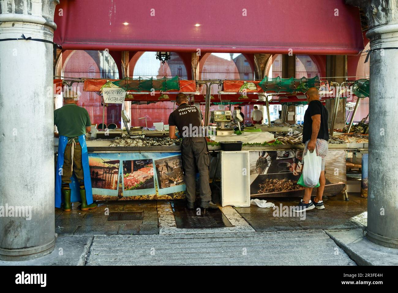 Pescivendoli al lavoro sotto la Loggia del mercato ittico di campo della Pescaria, sestiere di San Polo, in estate, Venezia, Veneto, Italia Foto Stock