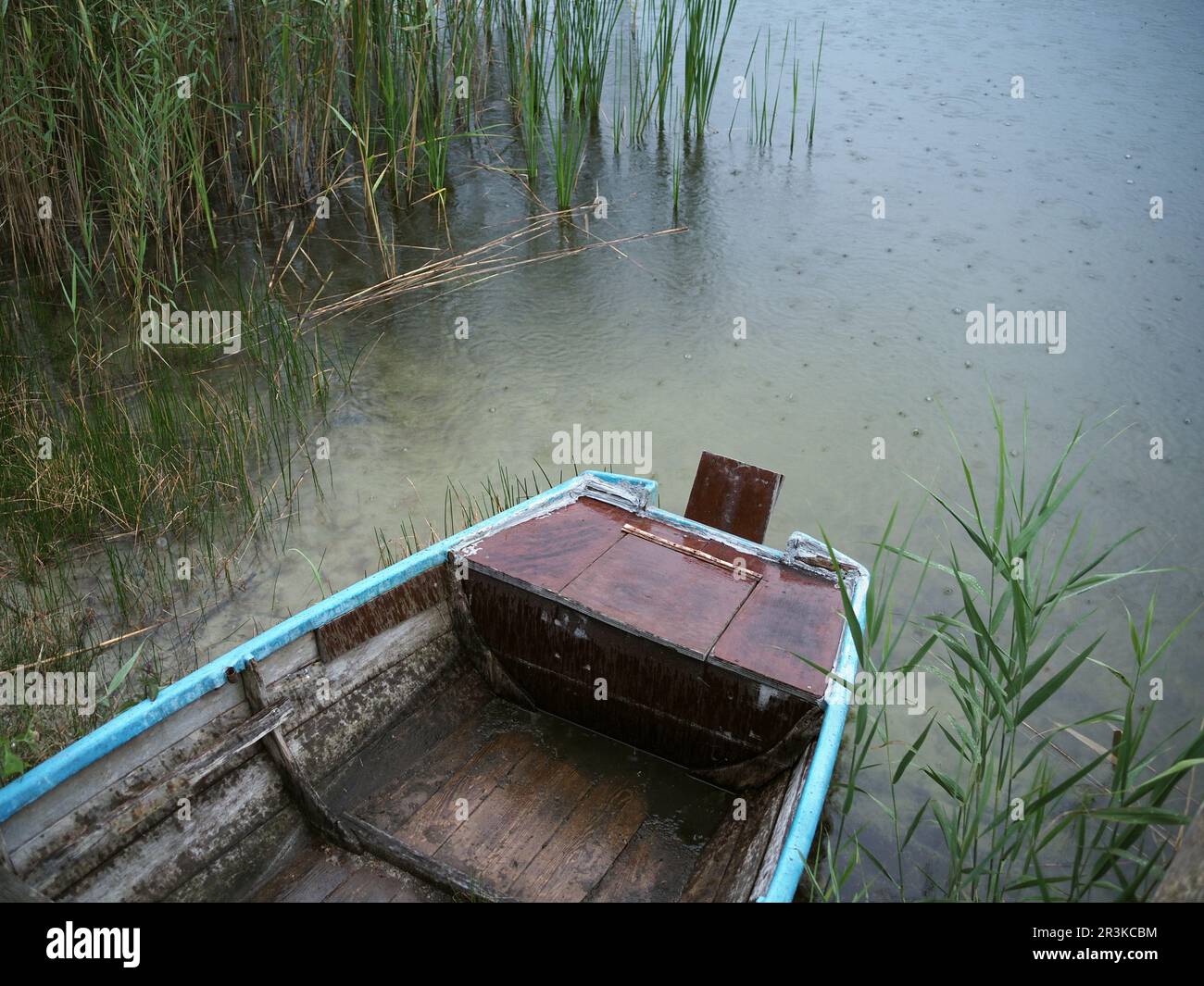 Row Boat sotto la pioggia su un lago Foto Stock