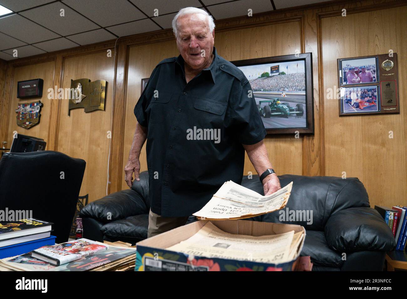 A.J. Foyt sifts through newspaper clippings inside his office ...