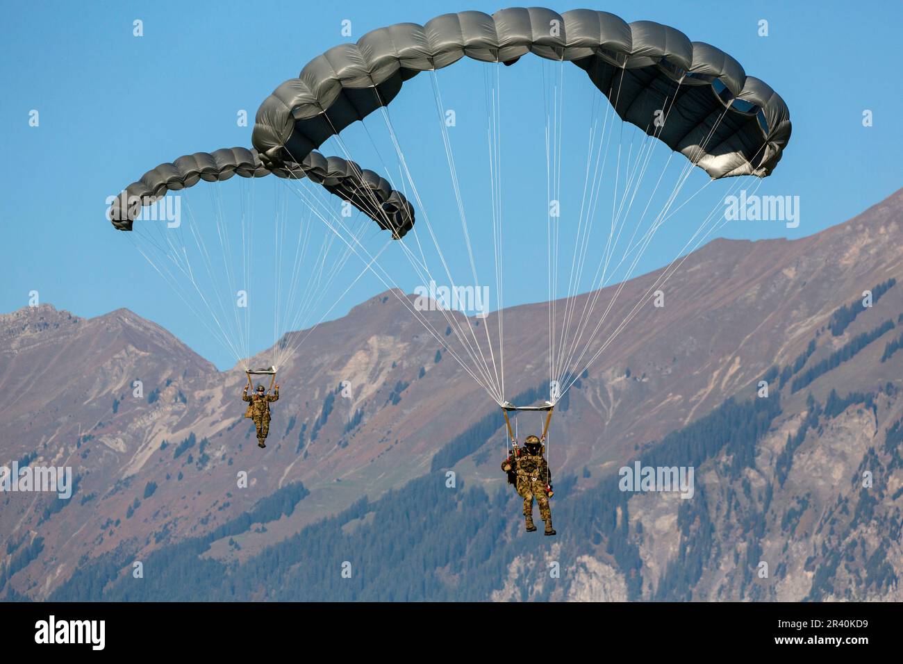 Paracadutisti dell'esercito svizzero che scendono attraverso il cielo, Meiringen, Svizzera. Foto Stock