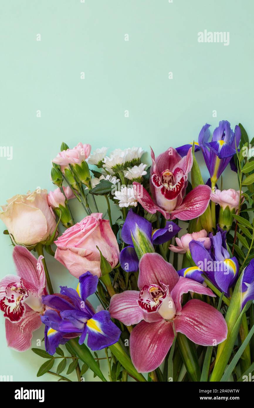 Giorno della madre o sfondo di compleanno. Primavera bellissimo bouquet su uno sfondo verde. Vista dall'alto piatto per saluti con spazio Foto Stock