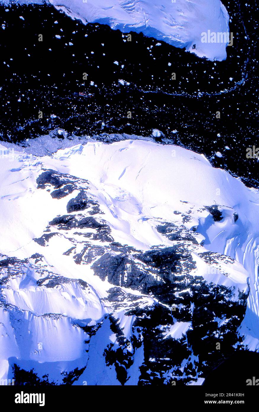 Grahamland Antartide 1972 HMS Endurance centro cima del telaio tagliare un canale attraverso i pacchetti di ghiaccio iceberg in canali contro il mare blu scuro si deve guardare davvero duro, ma la vernice rossa della nave può essere visto Foto Stock