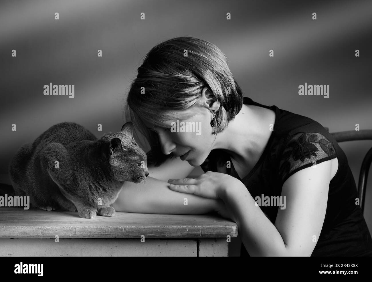 Ritratto di una donna con il suo gatto pedigree Blu russo che mostra il suo affetto Foto Stock