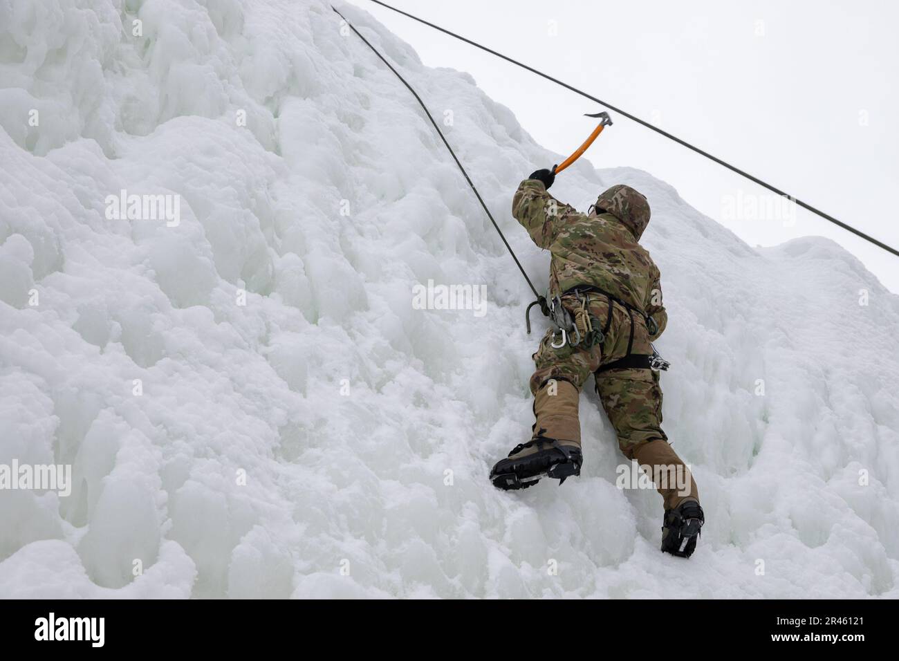 STATI UNITI Il ghiaccio del soldato dell'esercito sale durante l'addestramento di sostegno condotto dalla Alpha Company, 3rd battaglione, 172nd montagna di reggimento della fanteria), 86th squadra di combattimento della Brigata della fanteria (montagna), Guardia Nazionale dell'esercito del Vermont, all'Ethan Allen Firing Range, Jericho, Vt., 5 marzo 2023. L'attrezzatura speciale, come gli assi di arrampicata, l'imbracatura per sedersi, i moschettoni e i ramponi, consente ai soldati di affrontare terreni ripidi e ostacoli verticali altrimenti impraticabili. Foto Stock