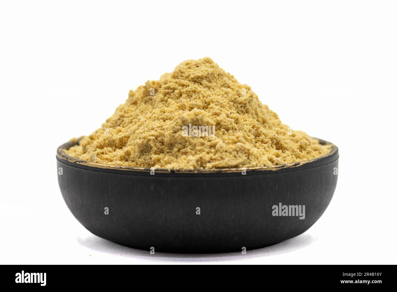 Polvere di zenzero isolata su sfondo bianco. Polvere di zenzero in ciotola Foto Stock