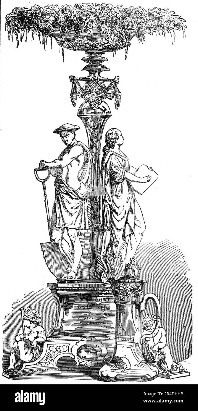 Testimonianza presentata al Sig. C. A. Saunders, Great Western Railway, 1856. 'Il testimonial, che era stato ottenuto così privatamente che il sig. Saunders non ne conosceva niente fino a pochi giorni dalla presentazione, consiste in un paio di brocche d'argento Claret e un Epergne elegante, sostenuto da figure finemente modellate di giustizia, industria e saggezza. Il piatto è stato progettato e realizzato dai signori Hunt e Roskell: L'epergne è sormontato da alcuni squisiti fiori artificiali provenienti dallo studio della signora Stodart, artista floreale di grande talento...[l'iscrizione recita:] presentato dagli ufficiali e dai princi Foto Stock