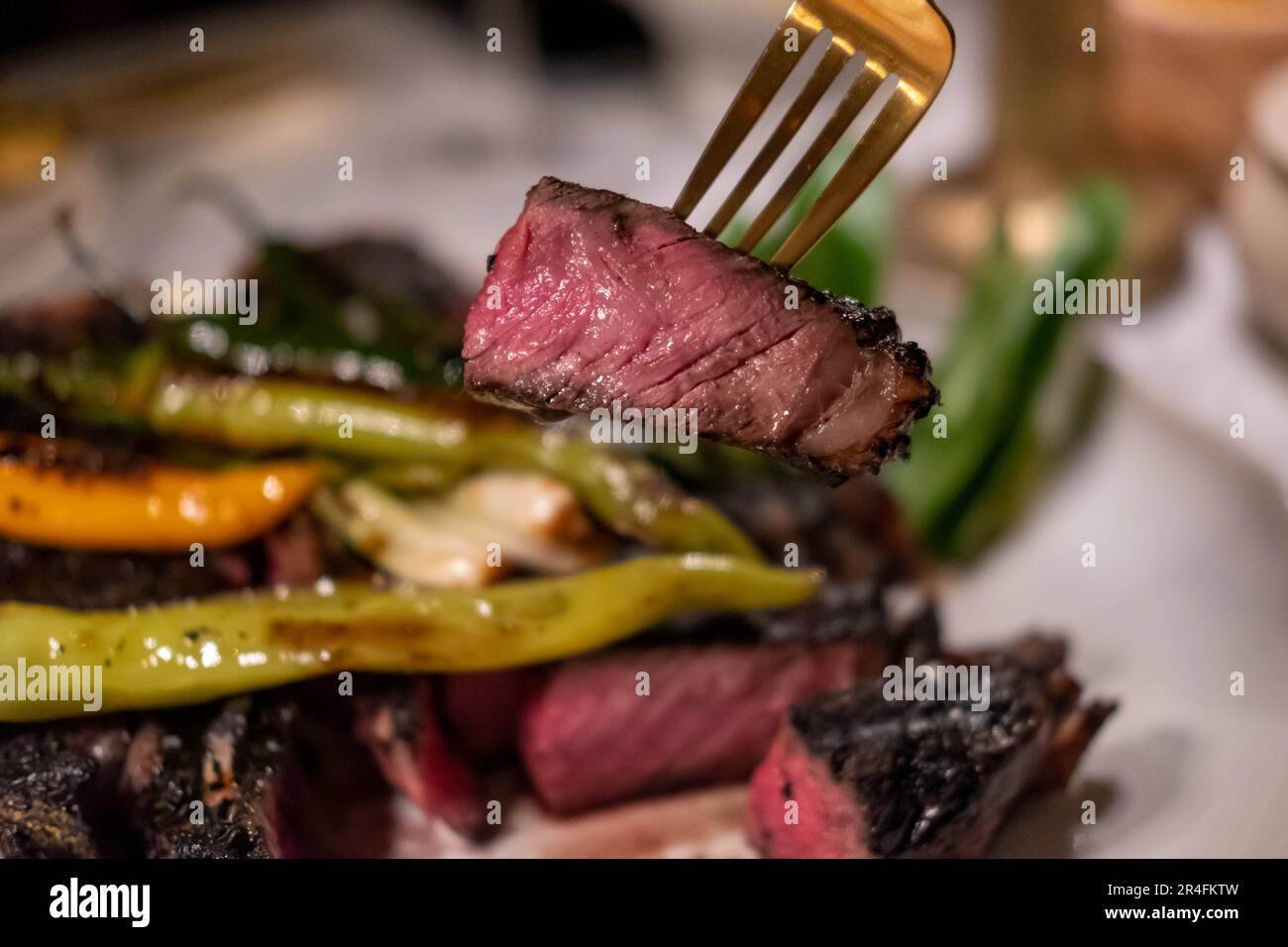 Carne asada, un manzo ribeye alla griglia e affettato servito su piatto con cipolle toreado. È un piatto messicano. Foto Stock