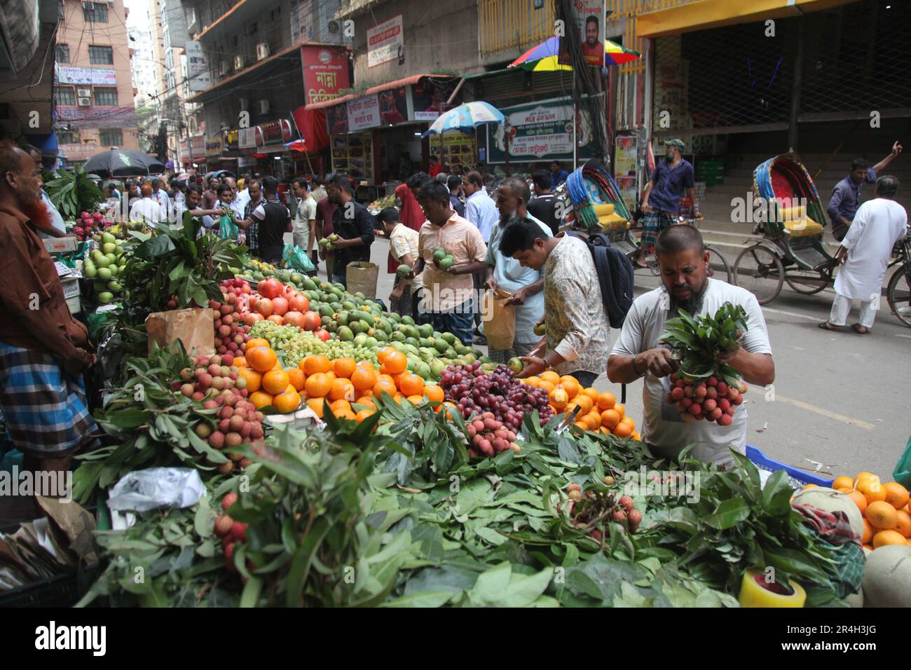 Dhaka, Bangladesh. Il venditore del Bangladesh vende frutta su un mercato di strada a Dhaka, Bangladesh, il 25 maggio 2023. Il Bangladesh importa circa 1,58 milioni di chilogrammi Foto Stock
