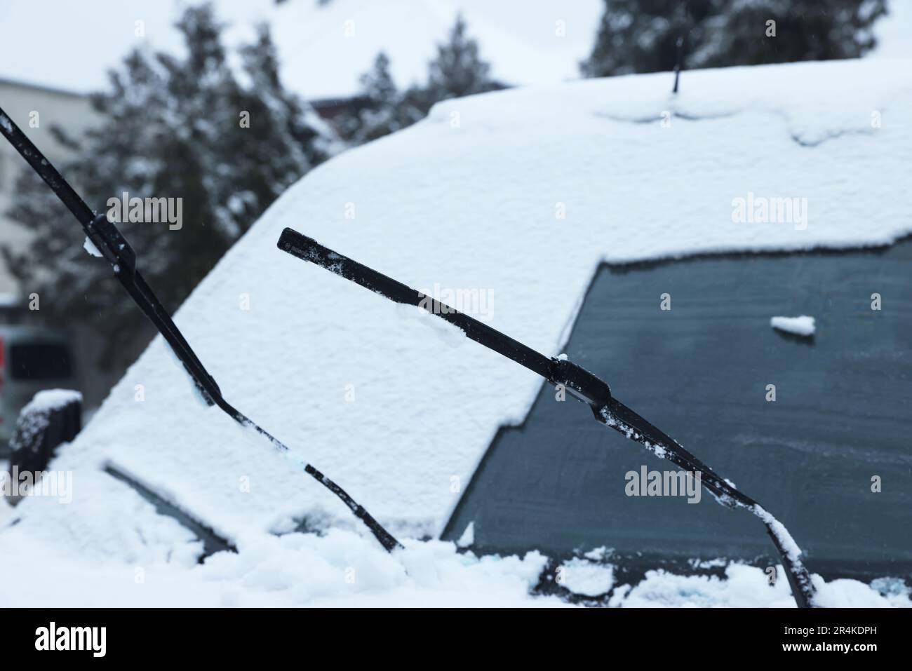 Auto con tergicristalli coperti di neve all'aperto nei giorni invernali Foto Stock