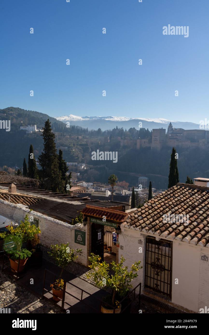 Vista dalla collina di Granada. Autentica architettura mediterranea. Sullo sfondo il complesso dell'Alhambra e la catena montuosa della Sierra Nevada a Spane. Foto Stock