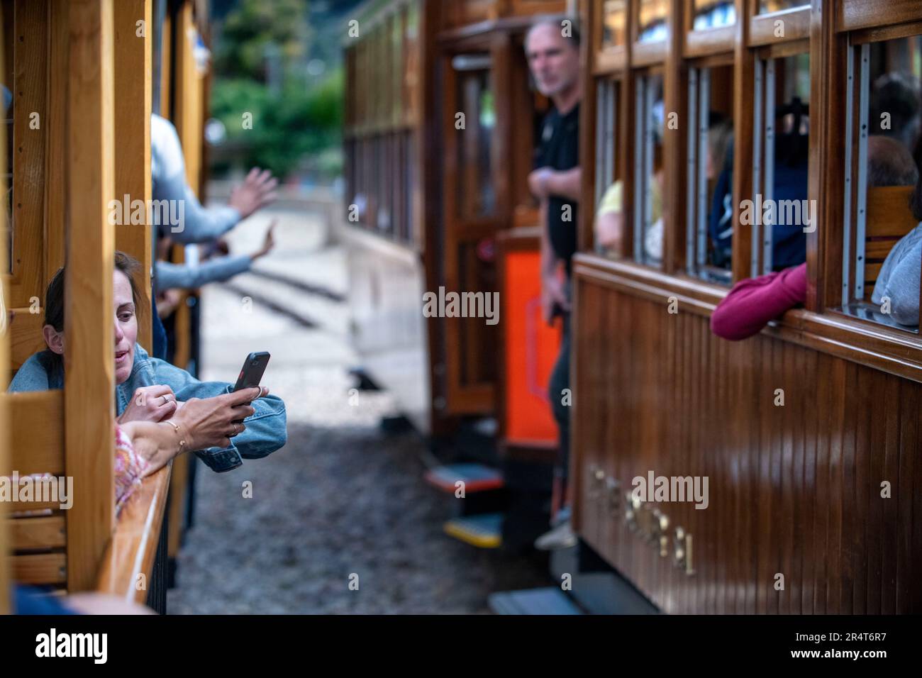 Turisti all'interno del tram d'epoca al porto di Soller centro villaggio. Il tram opera un servizio 5kms dalla stazione ferroviaria nel villaggio di Soller Foto Stock