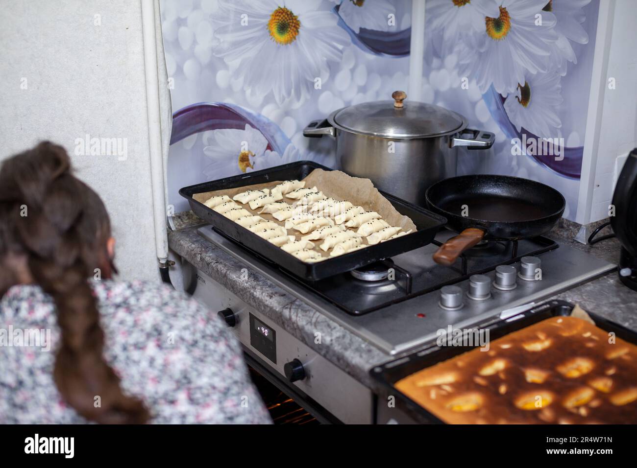Il processo di preparazione di croissant fatti in casa e altri dolci. La famiglia sta cucinando il dessert insieme in cucina. Foto Stock