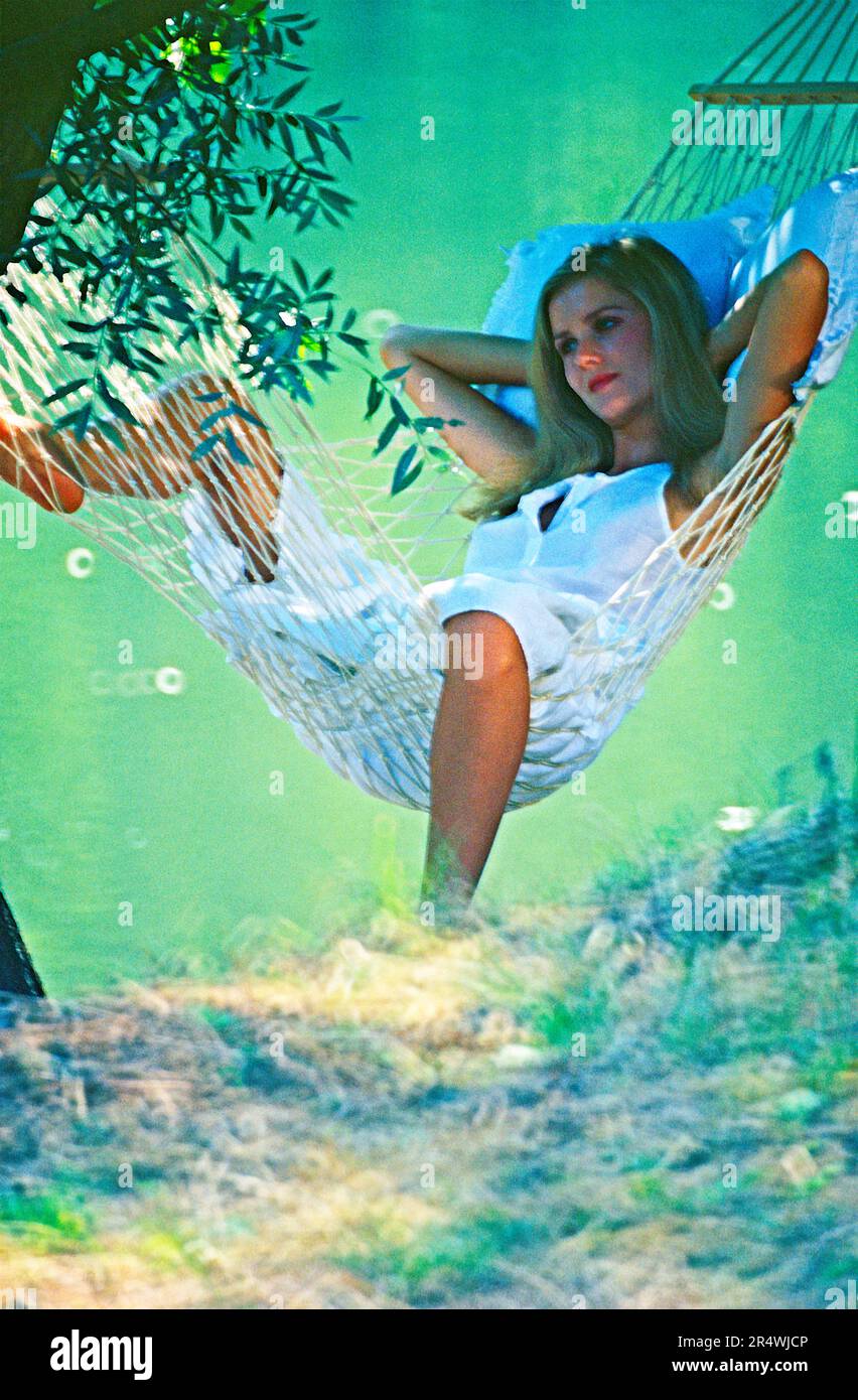 Francia. Dordogna. Giovane donna in amaca sul fiume. Foto Stock